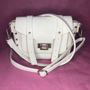 White buckle strap cross body purse.